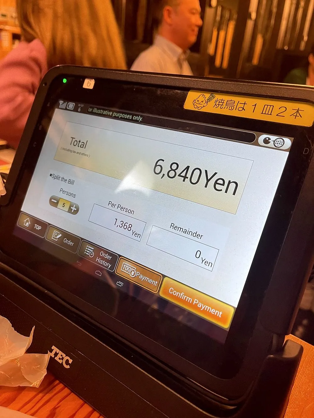 A tablet payment terminal at a Torikizoku yakitori restaurant in Asakusa displaying a total bill of 6,840 yen split five ways at 1,368 yen per person.